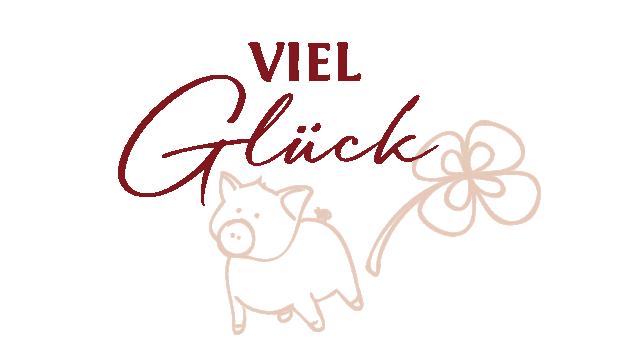 Glücksschwein neben einem Kleeblatt mit Beschriftung Viel Glück